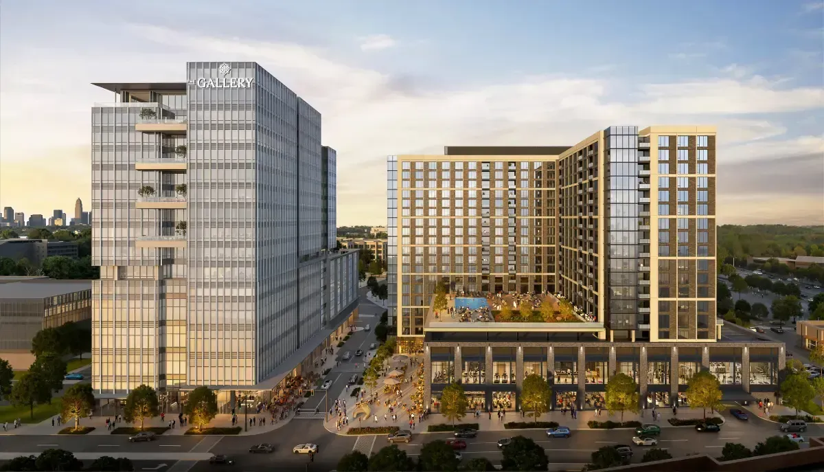 Wide architectural rendering of "The Gallery" mixed-use complex, showing a glass office tower on the left and an L-shaped residential building with an outdoor pool deck on the right.