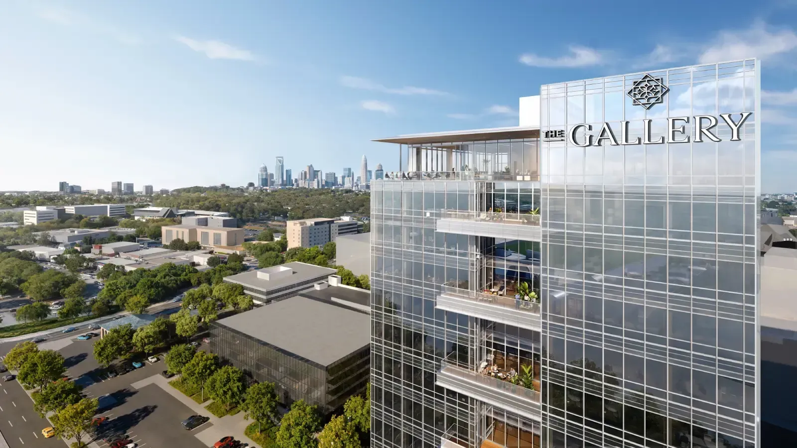 Architectural rendering focusing on the upper floors of "The Gallery" glass office tower, featuring stacked open-air balconies and a distant city skyline in the background.